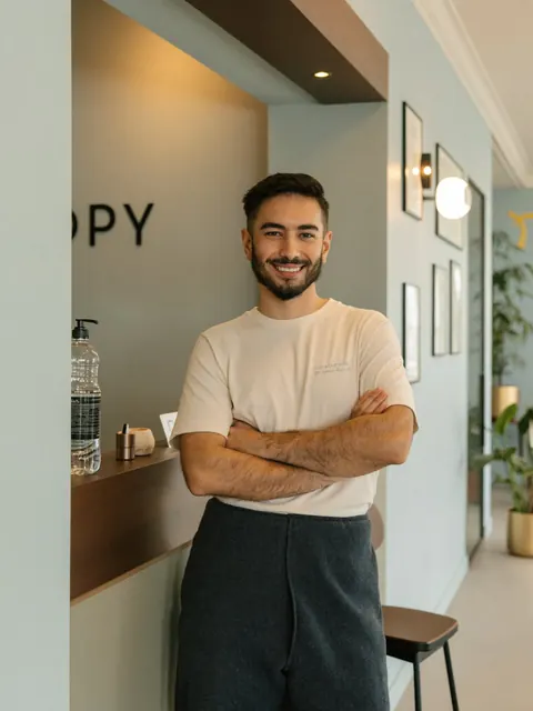 Med spa owner standing at his reception desk
